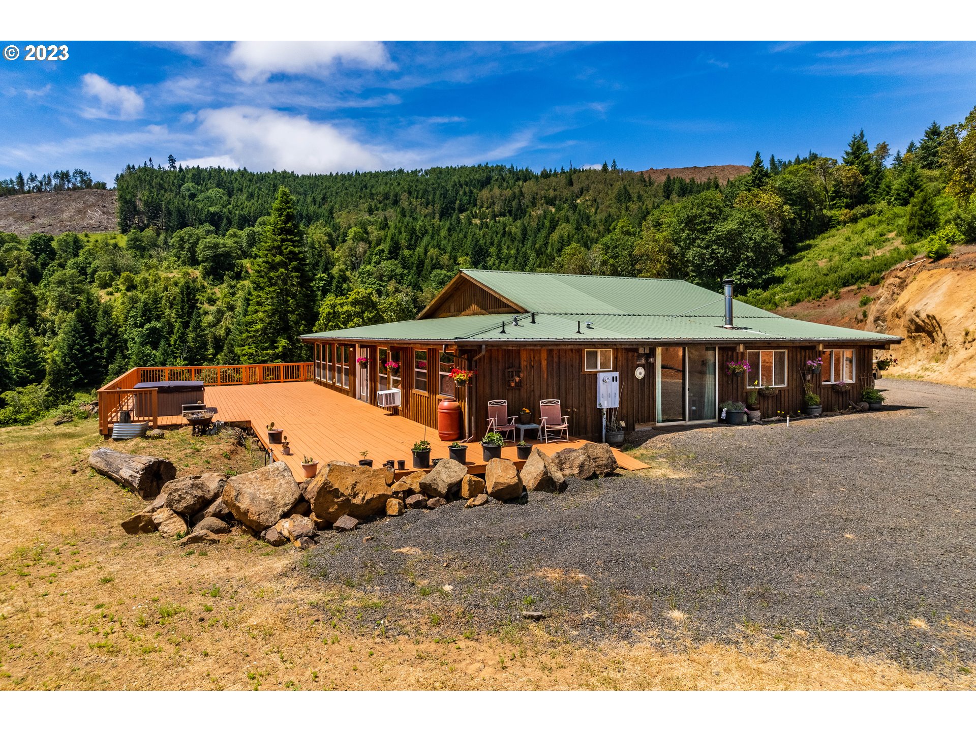 11937 Elkhead Road Yoncalla, OR 97499 - Photo 3 of 41 a view of a white house with a big yard