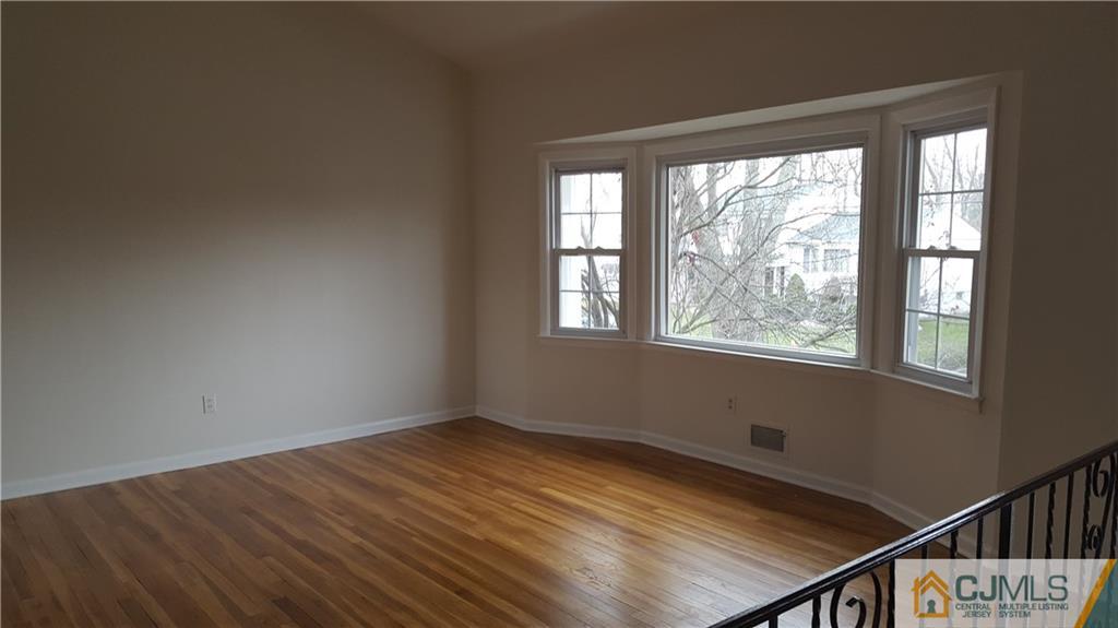 9 Gramercy Road Old Bridge, NJ 08857 - Photo 2 of 7 a view of empty room with wooden floor and fan