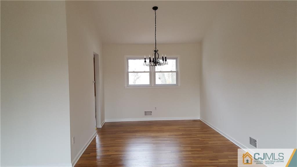 9 Gramercy Road Old Bridge, NJ 08857 - Photo 3 of 7 a view of empty room with wooden floor and fan