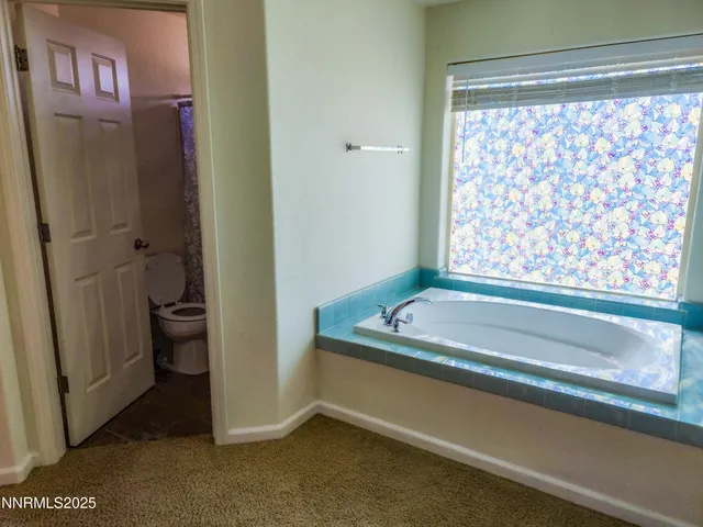 a bathroom with a shower toilet and sink