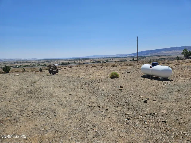 view of a dry yard with wooden fence