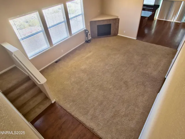 a view of an empty room and wooden floor