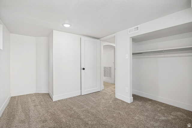 662 29th Street Ogden, UT 84403 - Photo 16 of 23 Carpeted room featuring white walls, recessed ceiling lighting, a built-in closet with hanging rod, and white trim throughout
