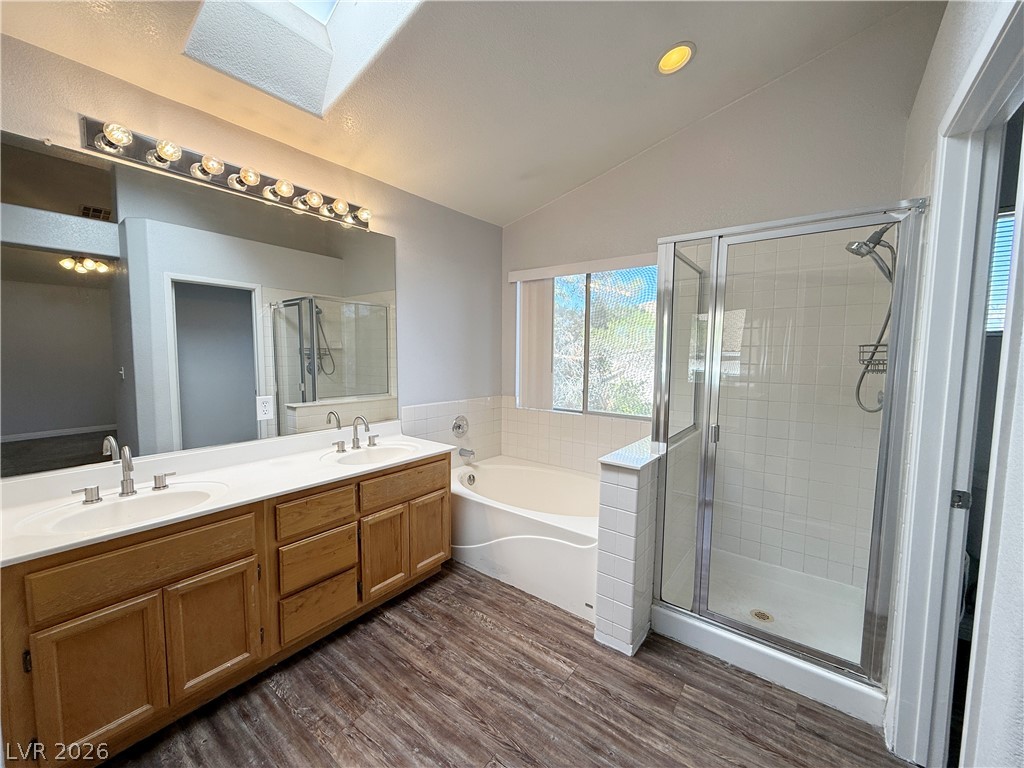 2185 Polynesia Circle Henderson, NV 89074 - Photo 33 of 37 Dual vanities and a skylight illuminate this well-appointed primary bathroom.