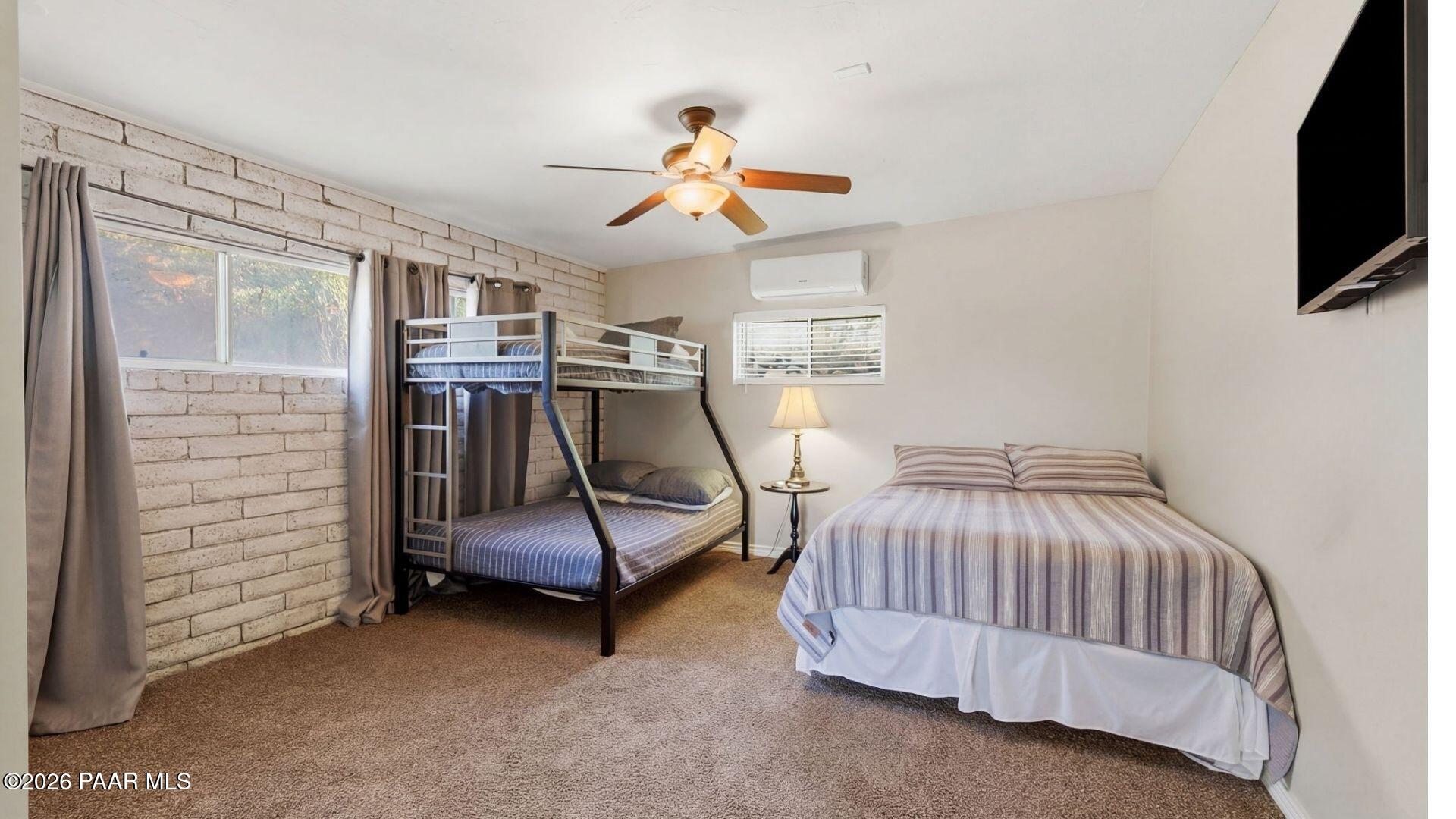 803 East Carleton Street Prescott, AZ 86303 - Photo 19 of 43 a bedroom with a bed and a flat screen tv