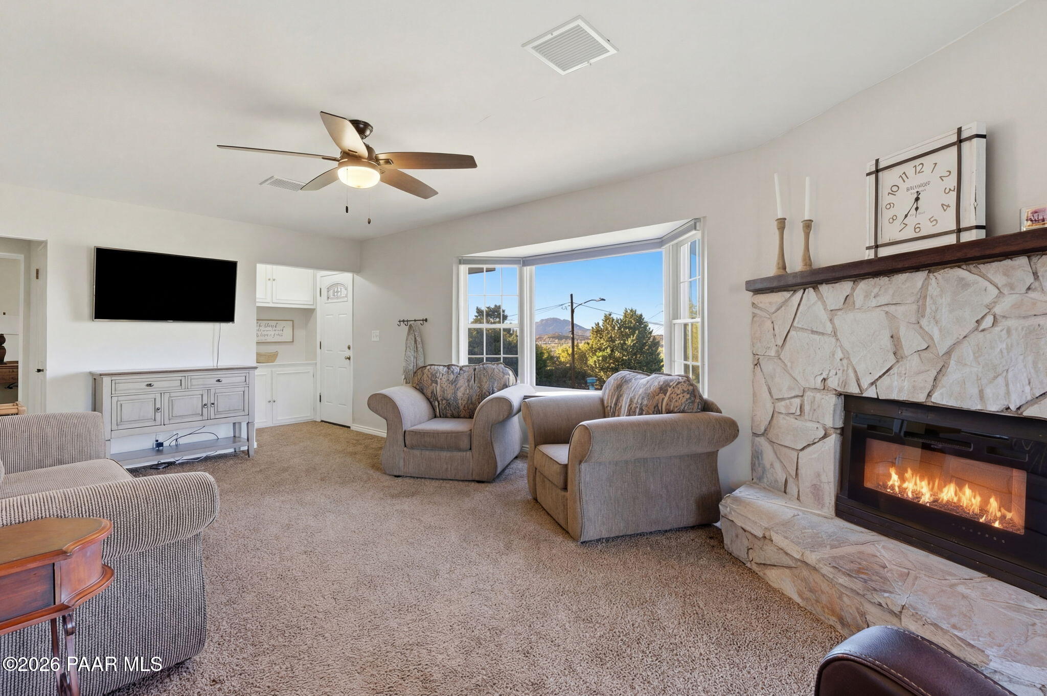 803 East Carleton Street Prescott, AZ 86303 - Photo 6 of 43 a living room with furniture a fireplace and a flat screen tv