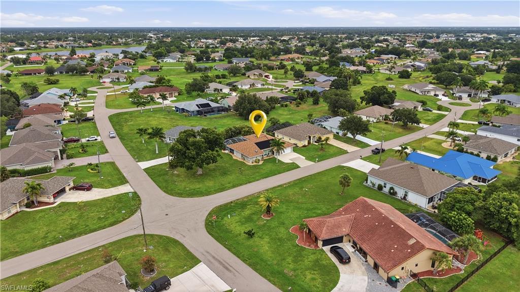 25378 Rupert Road Punta Gorda, FL 33983 - Photo 2 of 50 Aerial perspective showcasing a residential neighborhood with single-story homes and a prominent lake in the background