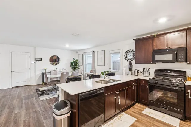 a kitchen with a stove a sink and a refrigerator