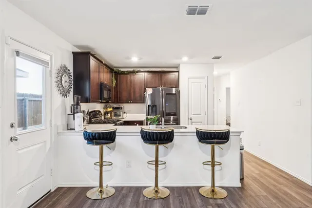 a view of kitchen with appliances and living room
