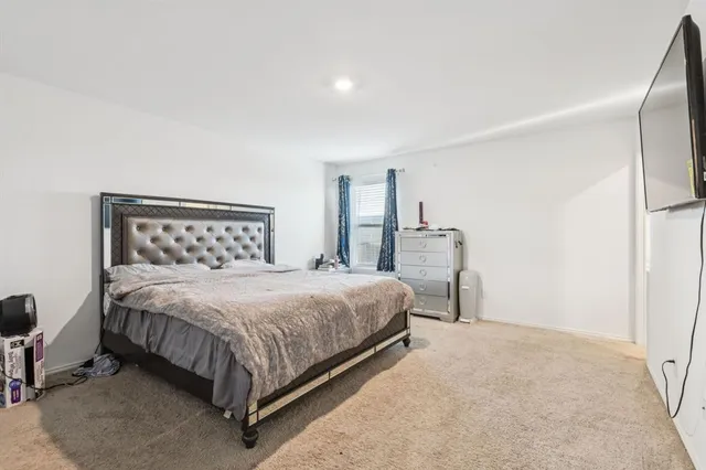 a bedroom with a bed and chair