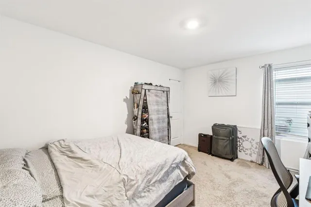 a bedroom with a bed and a chair