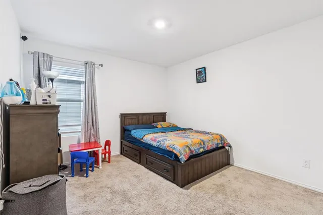 a bedroom with a bed and a table in it