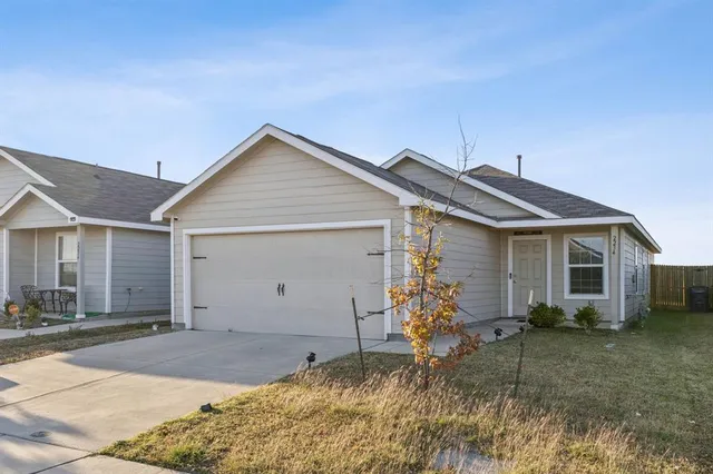 a view of a house with a yard and garage
