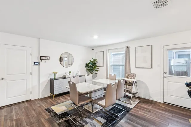 a living room with furniture a table and wooden floor