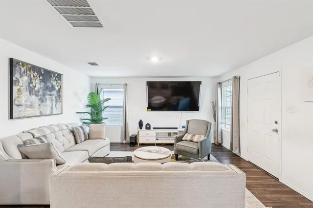 a living room with furniture a couch and a flat screen tv