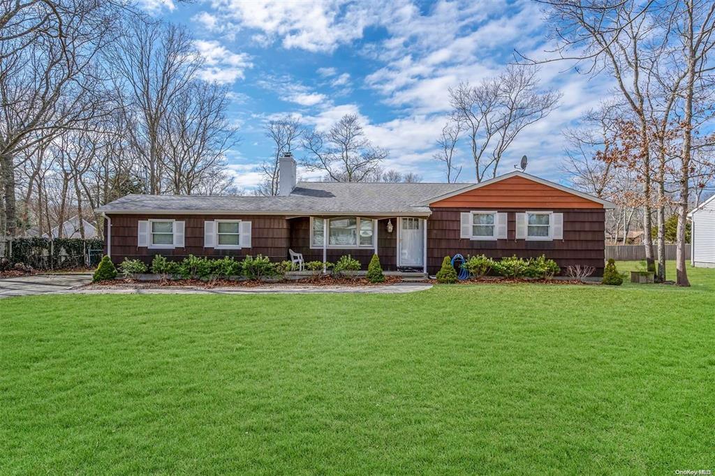 a front view of a house with yard porch and furniture