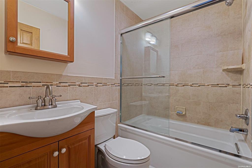 168 West Tiana Road Hampton Bays, NY 11946 - Photo 12 of 17 a bathroom with a sink toilet and shower