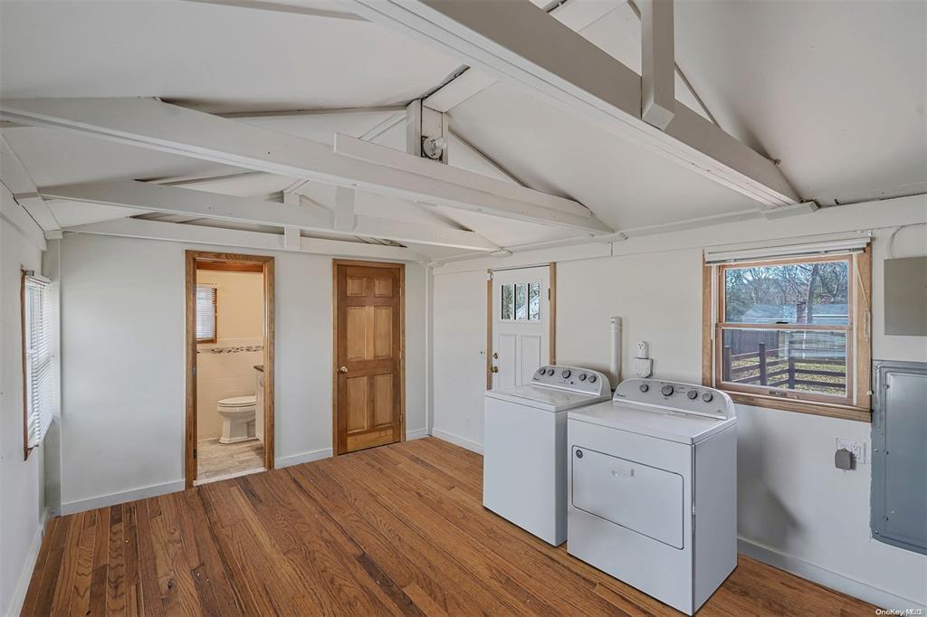 168 West Tiana Road Hampton Bays, NY 11946 - Photo 13 of 17 a view of a hallway with washer and dryer