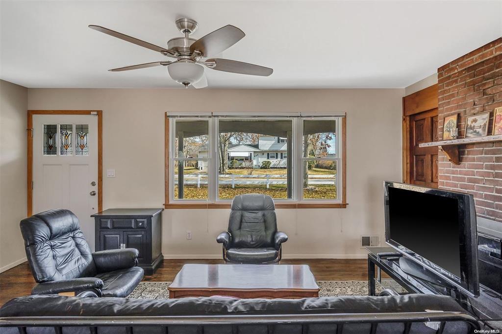168 West Tiana Road Hampton Bays, NY 11946 - Photo 2 of 17 a living room with furniture and a flat screen tv