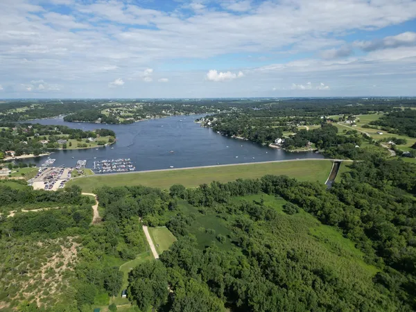 an aerial view of residential building and lake