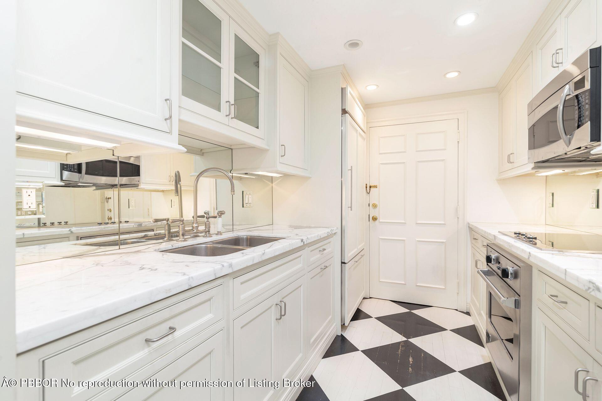 330 Cocoanut Row, Unit 12 Palm Beach, FL 33480 - Photo 8 of 19 a kitchen with a sink a stove and cabinets