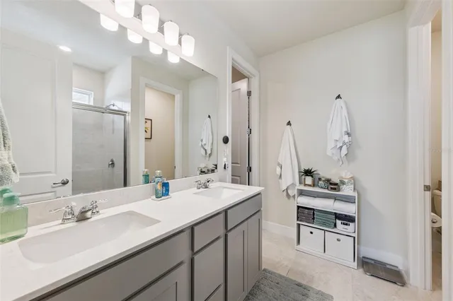 a bathroom with a sink vanity and a mirror