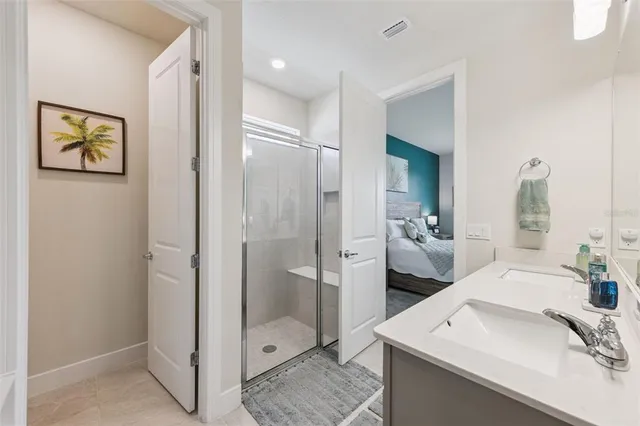 a bathroom with a double vanity sink mirror and shower