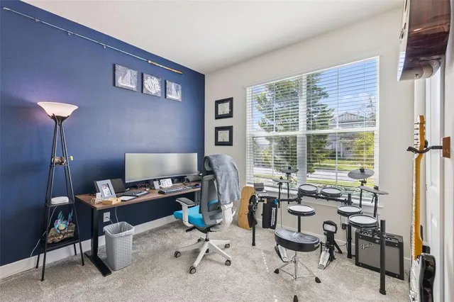 a view of a workspace with furniture and a window