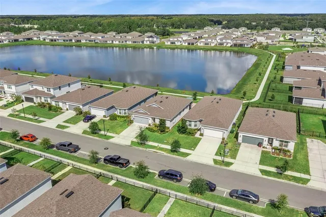 an aerial view of a house with a lake view