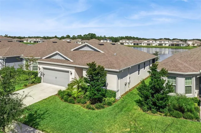 an aerial view of residential houses with outdoor space and city view