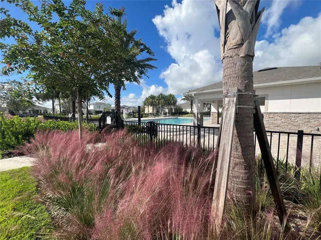 a yellow house in middle of the middle of garden