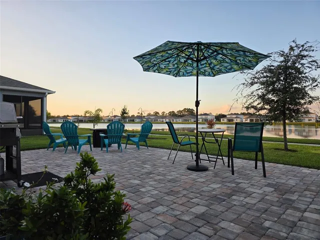 a view of a swimming pool and lounge chairs in the garden