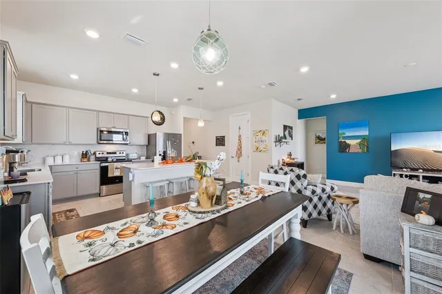 a large kitchen with a table and chairs