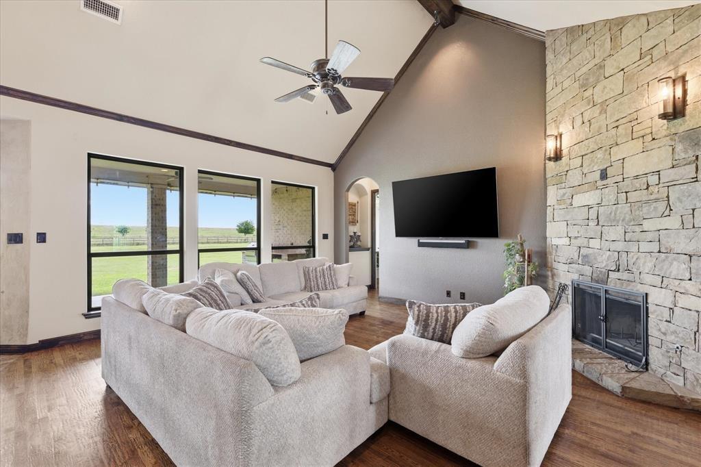 160 Vista Ridge North Decatur, TX 76234 - Photo 9 of 40 a living room with furniture a flat screen tv and a fireplace