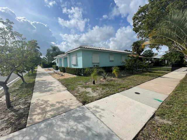 a backyard of a house with table and chairs