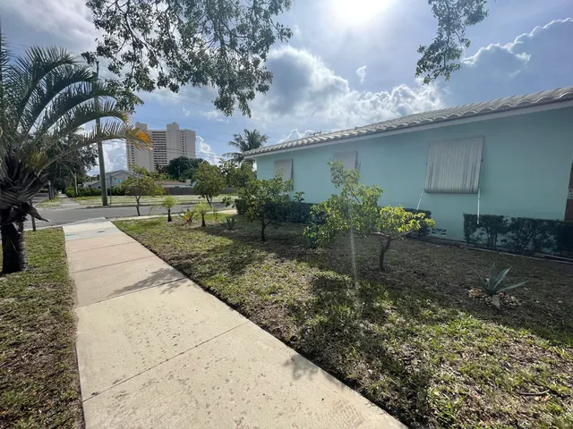 a bathroom with a sink a toilet a mirror and shower