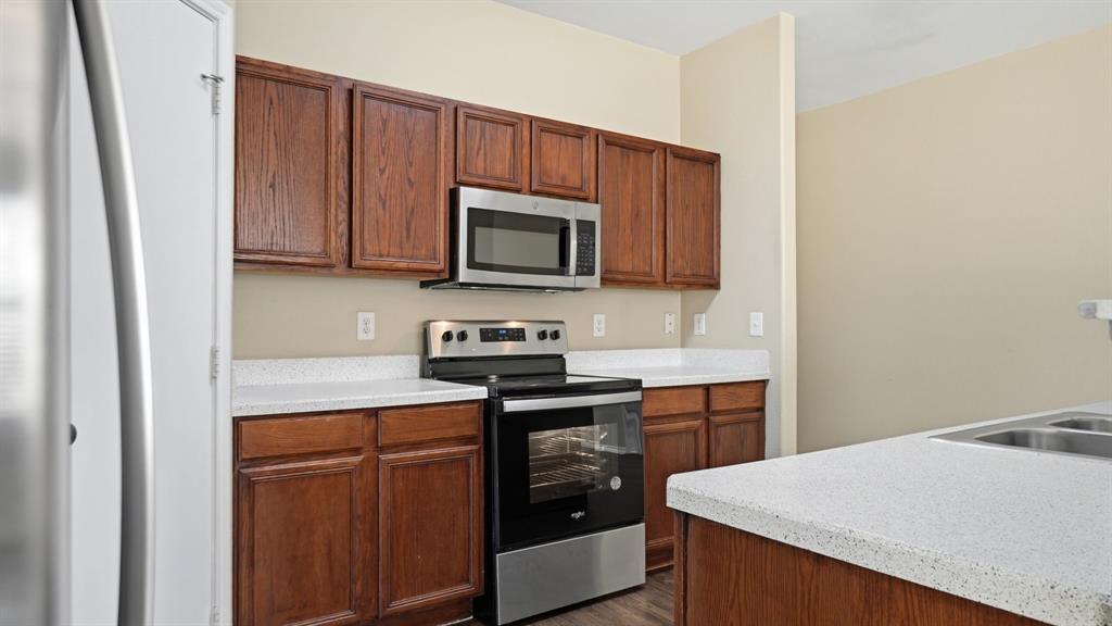 101 Long Prairie Drive Forney, TX 75126 - Photo 11 of 40 a kitchen with stainless steel appliances a stove microwave and sink
