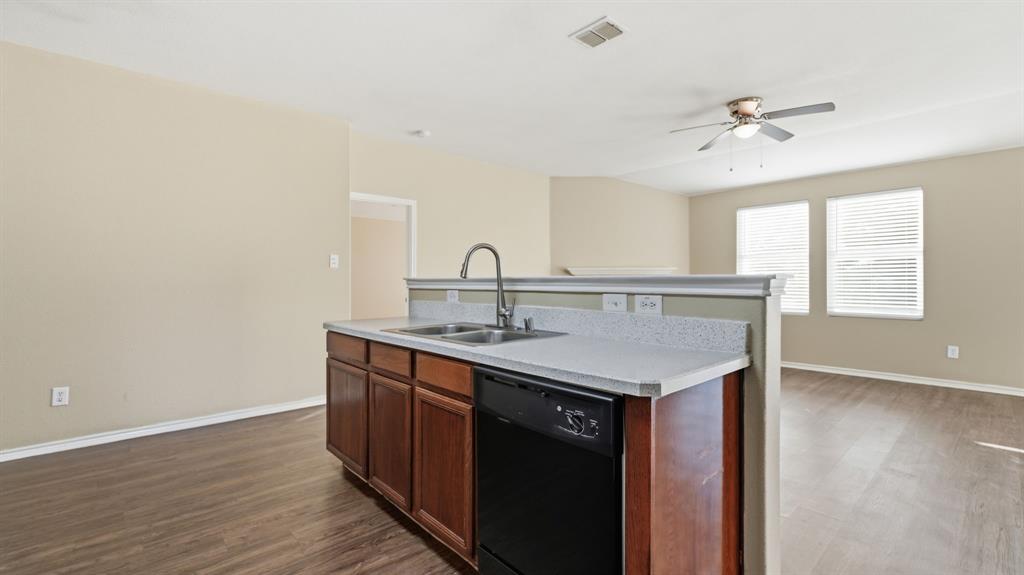 101 Long Prairie Drive Forney, TX 75126 - Photo 12 of 40 a kitchen with a sink cabinets and wooden floor