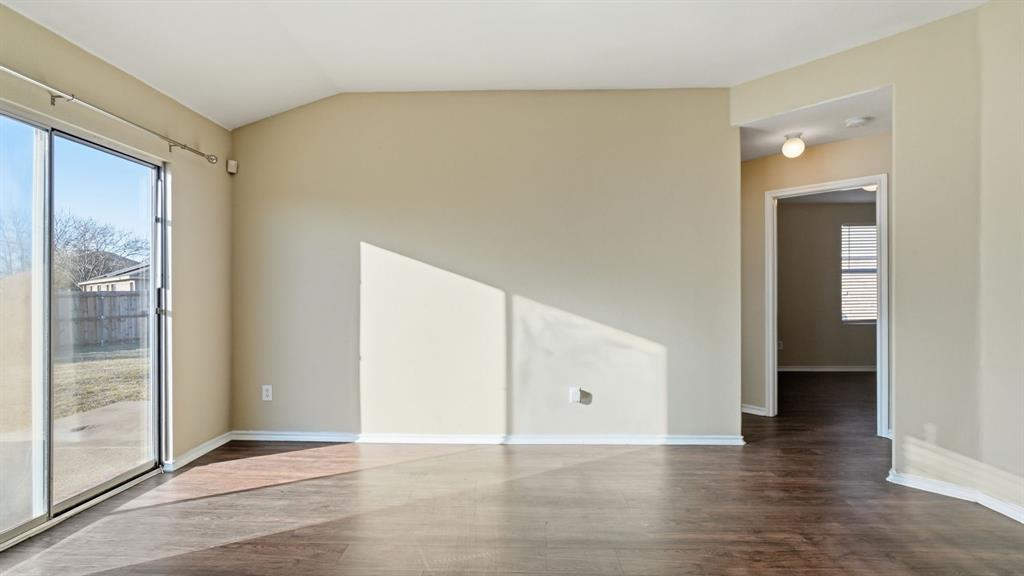 101 Long Prairie Drive Forney, TX 75126 - Photo 16 of 40 a view of an empty room with wooden floor and a window