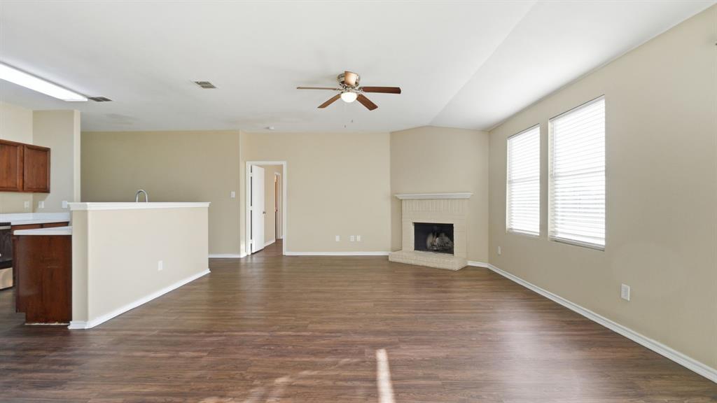 101 Long Prairie Drive Forney, TX 75126 - Photo 17 of 40 an empty room with windows and fireplace