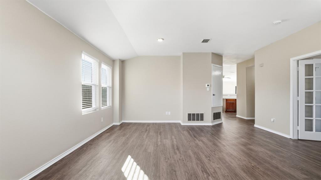 101 Long Prairie Drive Forney, TX 75126 - Photo 19 of 40 an empty room with wooden floor and windows
