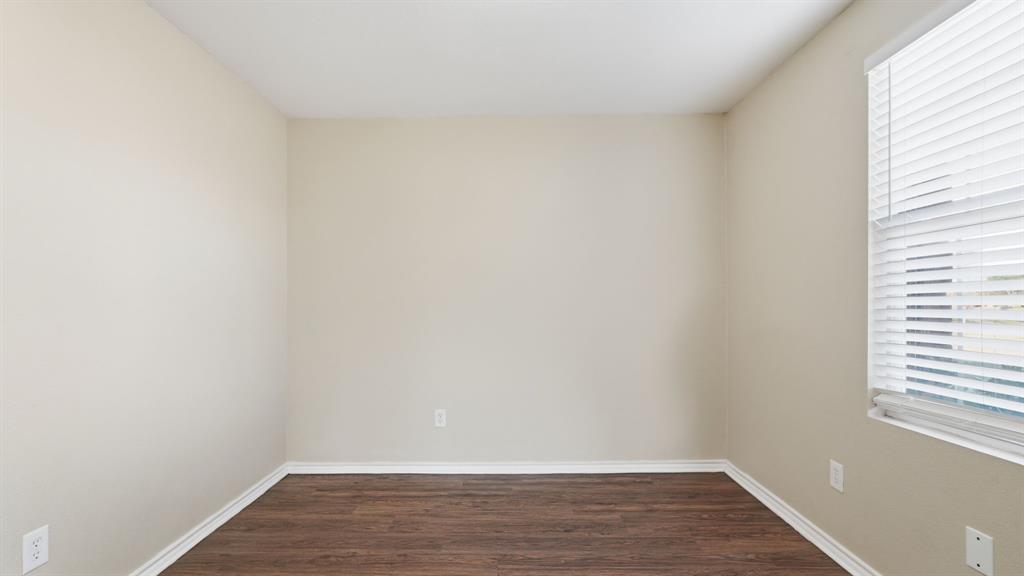 101 Long Prairie Drive Forney, TX 75126 - Photo 22 of 40 a view of an empty room with wooden floor and a window