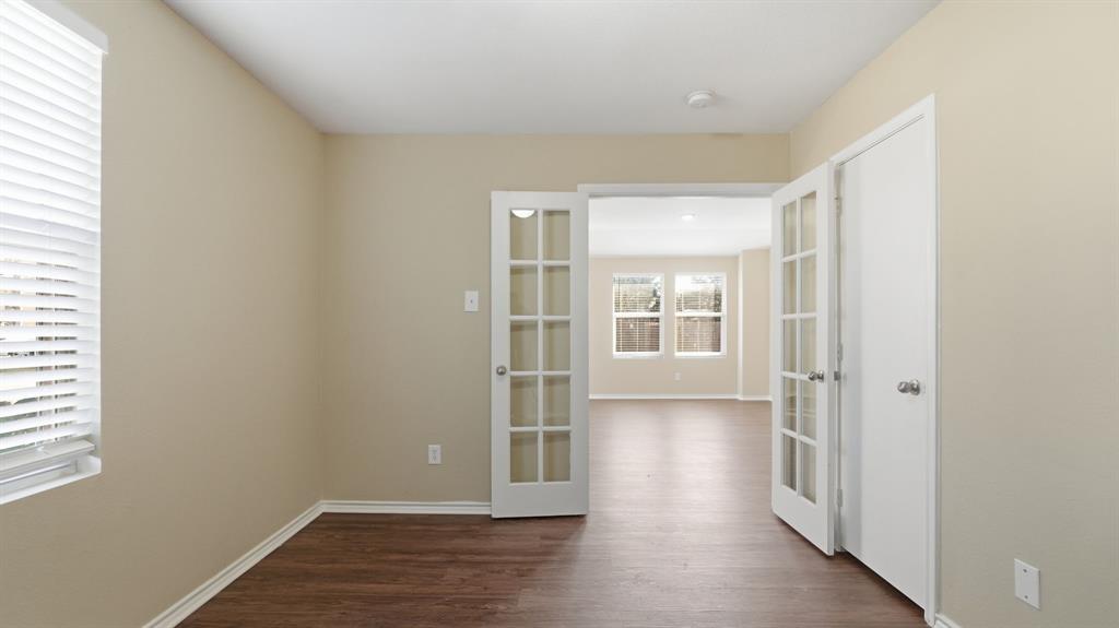 101 Long Prairie Drive Forney, TX 75126 - Photo 23 of 40 an empty room with wooden floor and windows