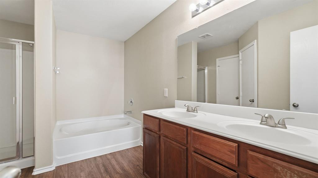 101 Long Prairie Drive Forney, TX 75126 - Photo 27 of 40 a bathroom with a tub sink double vanity granite tub and shower