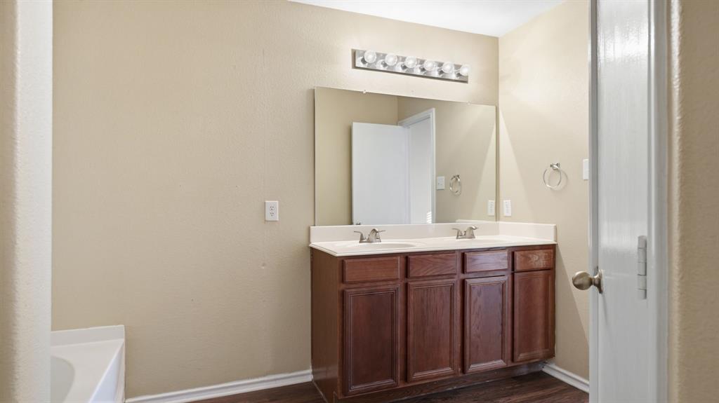 101 Long Prairie Drive Forney, TX 75126 - Photo 28 of 40 a bathroom with a sink and a mirror
