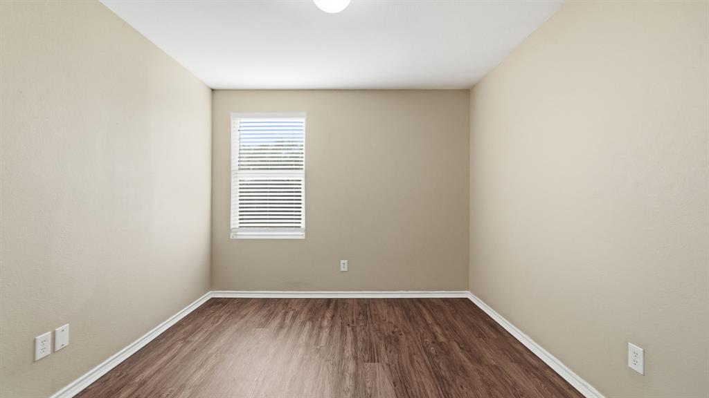 101 Long Prairie Drive Forney, TX 75126 - Photo 29 of 40 a view of a room that has wooden floor and a window