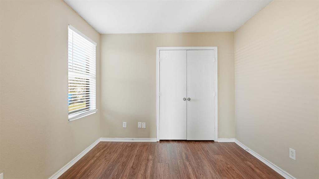 101 Long Prairie Drive Forney, TX 75126 - Photo 32 of 40 an empty room with wooden floor and windows