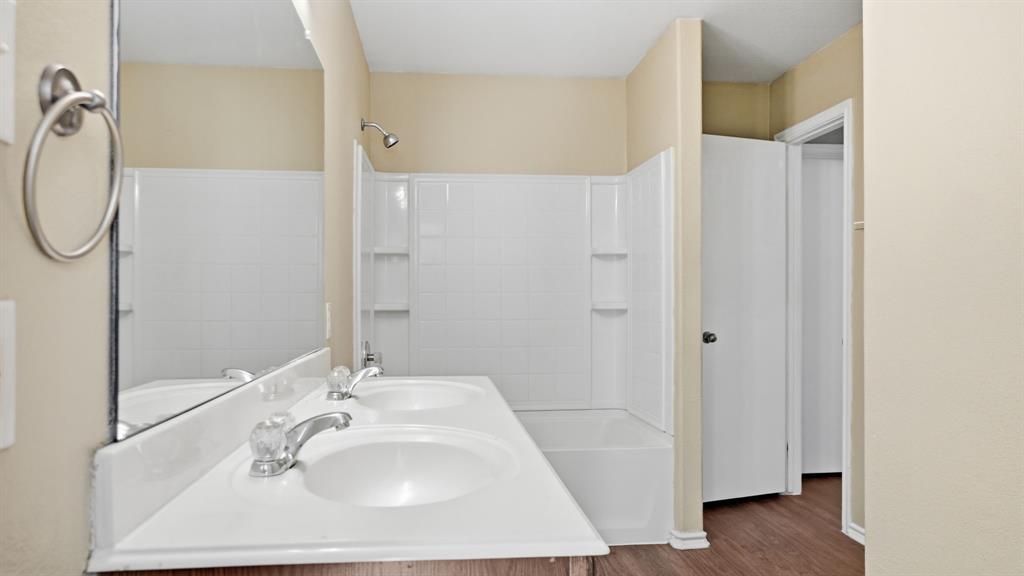 101 Long Prairie Drive Forney, TX 75126 - Photo 34 of 40 a bathroom with a sink a mirror and shower