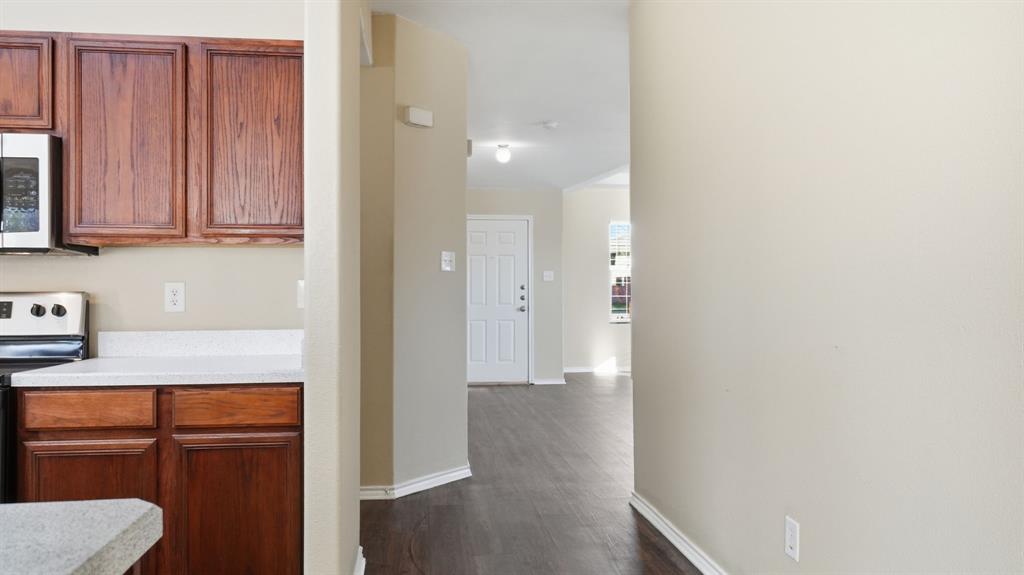 101 Long Prairie Drive Forney, TX 75126 - Photo 39 of 40 a view of a hallway with wooden floor and cabinets