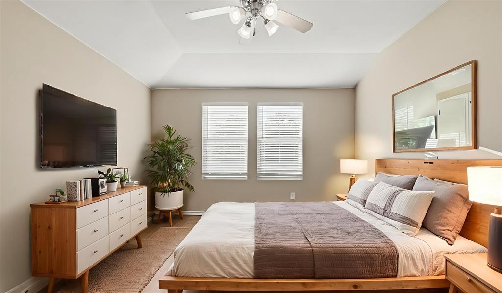 101 Long Prairie Drive Forney, TX 75126 - Photo 8 of 40 a spacious bedroom with a large bed and a flat screen tv